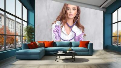 Sexy girl doctor in a white coat with a stethoscope
 Wall mural