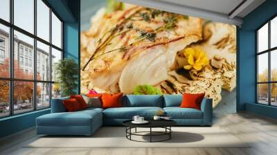 Sea or river baked white fish lies on a base of cauliflower vegetables with sauce. Decoration of flowers and herbs spices. A dish from the chef for serving Wall mural