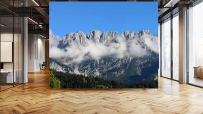 Kaiser Mountains beyond  2440 meters above sea level. Breathtaking scene with blue sky and white clouds between the alpine peaks and the valley. Beautiful and amazing Austrian alps. Sunny autumn day. Wall mural