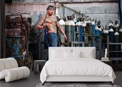 muscular man with an acetylene burner Wall mural