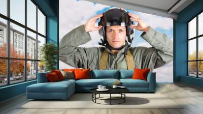 portrait of young pilot wearing helmet with a sky background Wall mural