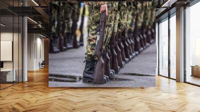 Soldiers stand in row. Gun in hand. Army, Military Boots lines of commando soldiers in camouflage uniforms Wall mural