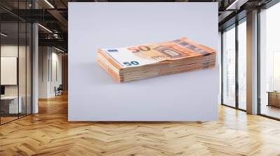 A stack of clear 50 euro banknotes on a gray background.  Wall mural