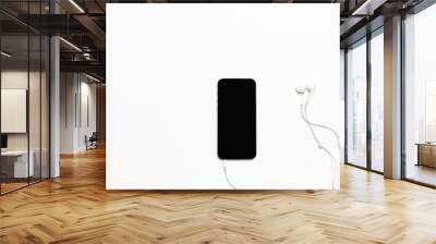 Mobile phone with white earphones isolated on white Wall mural