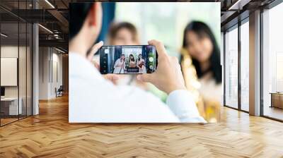 Group of happy women taking self-portrait and playing a clarinet and a violin stands by the window. Cozy home interior. looking in her telephone front view ,happy lifestyle concept. Wall mural