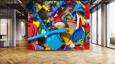 a bunch of plastic toys thrown in a sandbox Wall mural