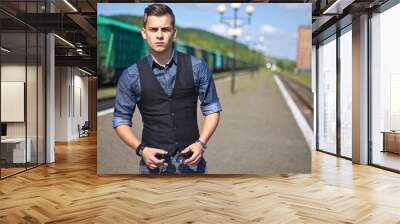 Handsome young man wearing casual and sunglasses standing outdoors. Wall mural