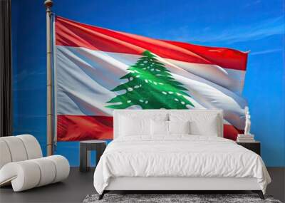 A vibrant red and white Lebanese flag waving gently in the wind, its central cedar tree emblem proudly displayed against a bright blue sky backdrop. Wall mural