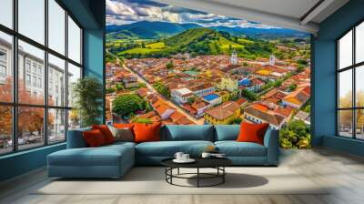 Bird's eye view of Florence, Caquetá, Colombia, showcasing the city's vibrant center with colorful buildings, roads, and lush green spaces amidst a stunning natural landscape. Wall mural