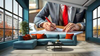 Business professional reviewing employment agreement documents at modern office desk, highlighting important clauses and terms with a red pen, close-up shot. Wall mural