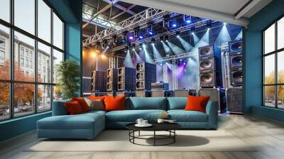 Modern professional sound reinforcement system with speakers, subwoofers, and audio equipment set up on stage for live concert or event in a large venue. Wall mural