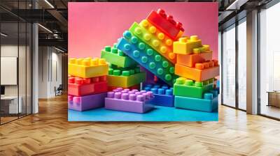 Vibrant rainbow colored plastic toy bricks stacked in a playful pile on a soft pastel background, symbolizing childhood creativity, education, and building imagination. Wall mural