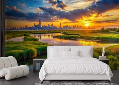 Vibrant sunset casts a warm glow on the lush green wetlands and serene waters of the Meadowlands, New Jersey, with Manhattan's skyline in the distance. Wall mural