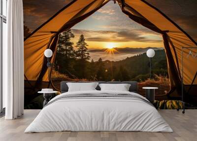 View of the serene landscape from inside a tent. Camping at campsite with sleeping bags. Stunning sunrise. Wall mural