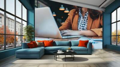 Businesswoman analyzing digital financial reports on a laptop, professional workspace, natural light, copy space Wall mural