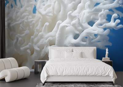 Close-up of a bleached coral against a deep blue sea backdrop, highlighting the texture and stark white color, Wall mural