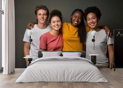 Group of happy multiracial teenage school students on gray background. Young people of different races, ethnic groups, different skin colors. Friendship, learning, education concept Wall mural