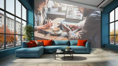 Business meeting. Teamwork. Businessman and businesswoman sitting at table and working. Wall mural