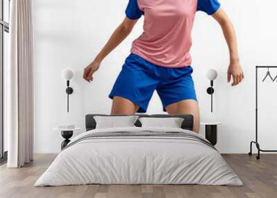 Female pro soccer player in active dribbling pose, wear a pink jersey on isolated background Wall mural