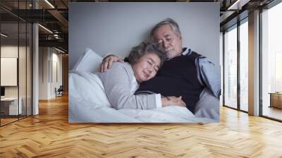 elderly couple caucasian senior man and woman sleeping and rest together in white blanket in bedroom, retirement health care with love lifestyle concept Wall mural