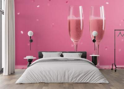 Two champagne glasses with splashes of confetti hearts on a pink background copy space Valentines Da Wall mural