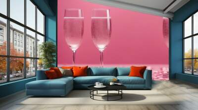 Two champagne glasses with splashes of confetti hearts on a pink background copy space Valentines Da Wall mural