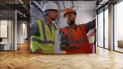 Engineers examining fire extinguishers on power plant Wall mural