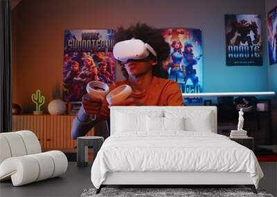 Teenage gamer in VR headset plays virtual online video game using wireless controllers. African American guy having fun in leisure time in his room. Gaming at home. View from PC screen perspective. Wall mural