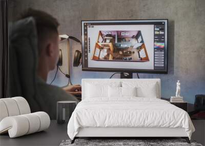 Young 3D designer creates and develops stylish house interior using PC and professional 3D modeling software or design app. Caucasian teenager works remotely on freelance project on computer at home. Wall mural