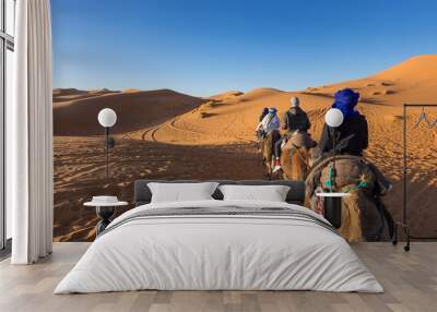 camel tour at sunset to erg chebbi in sahara desert, merzouga, morocco Wall mural