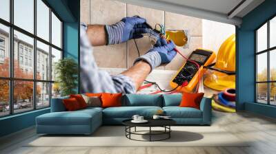 Electrician at work with safety equipment on a residential electrical system. Electricity. Wall mural