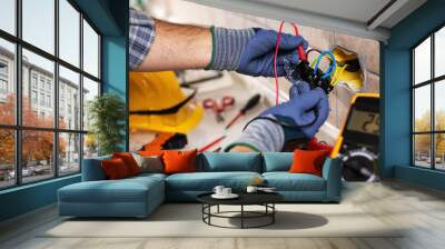 Electrician at work with safety equipment on a residential electrical system. Electricity. Wall mural