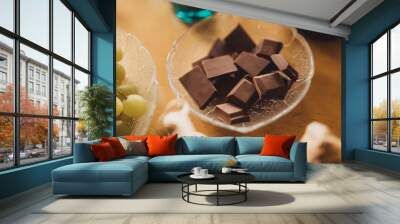 A glass bowl full of chocolate. Wall mural