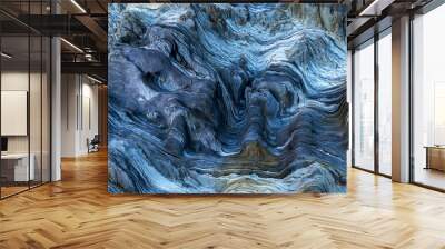 Detail of a rock with variants of blue. Rock full of curves and smooth cuts resulting from the erosive effect of sea. Close up rocks, texture dramatic and colorful erosional water formation. Wall mural