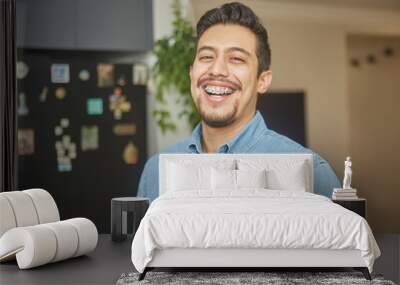 portrait of a hispanic young man with braces Wall mural