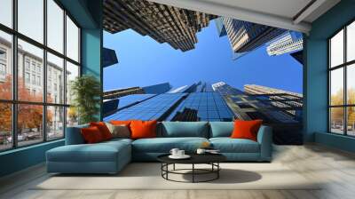 Upward view of skyscrapers in New York City, New York against clear blue sky. Wall mural