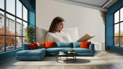 Relaxing afternoon of reading on a cozy sofa in a minimalist modern living room Wall mural