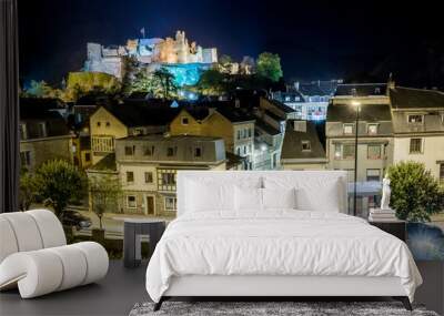 Night view of the Belgian city La Roche-en-Ardenne in Wallonia on the embankment of the river Ourthe, picturesque houses and streets with ruins of the medieval castle on the hilltop Wall mural