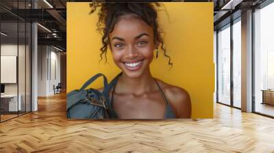 Energetic Fitness Model with Radiant Smile Holding Gym Bag on Pastel Yellow Background in High Resolution Quality Wall mural