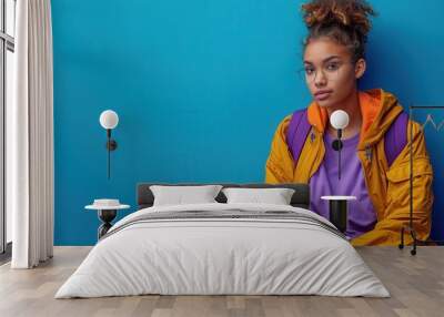 Thoughtful Student with Books Against Blue Background Wall mural