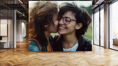 Two young happy women kissing Wall mural