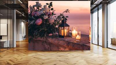 Candles and flowers as decorations in the evening. Wall mural