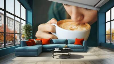 Close up girl is drinking coffee. She enjoys her morning cappuccino or flat white. Wall mural