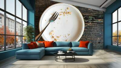 Conceptual image of the end of the holiday is an empty plate with crumbs and a fork on it. Wall mural