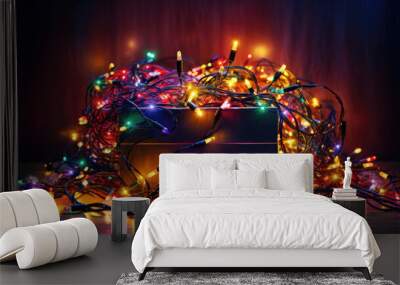 A box full of tangled and colorful fairy lights and other christmas ornaments and decorations Wall mural