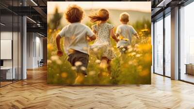 Back view of young children running over a blossoming meadow on a sunny summer day Wall mural