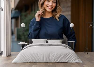 Woman's confident pose in navy sweatshirt amidst natural beauty  Wall mural