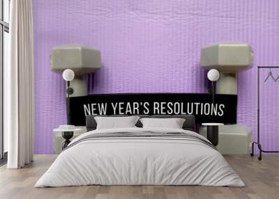 Inspirational new year resolution for fitness concept with exercise equipment background. Wall mural