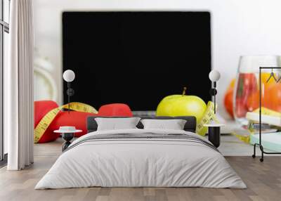 Close up green apple and dumbbell.  Healthy snack for diet planning for working in office.  Fresh  fruit with green fruit and tape measure Laptop background.  Healthy Lifestyle Concept Wall mural