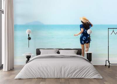 Summer vacations. Lifestyle woman relax and chill on beach background.  Asia happy young people running on the wave sea, summer trips walking enjoy  tropical beach Wall mural